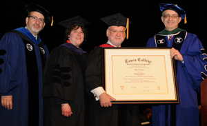 Rabbi Moshe Krupka, Touro Law Dean Patricia Salkin, Allen Fagin and Dr. Alan Kadish pose for a photo after presenting Mr. Fagin with an honorary degree at the Touro Law commencement ceremony.